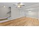 Bright living room featuring hardwood floors, crown molding, and a staircase at 1228 Archdale Dr # H, Charlotte, NC 28217