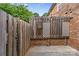 Outdoor patio with privacy fence with lattice and dart board, perfect for relaxing at 1228 Archdale Dr # H, Charlotte, NC 28217