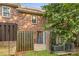 Cozy fenced in patio with brick wall and convenient outdoor storage unit at 1228 Archdale Dr # H, Charlotte, NC 28217
