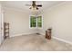 Light-filled bedroom offers neutral decor, a large window with green views, creating a calming atmosphere at 1302 N Ellis St, Salisbury, NC 28144