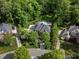 An aerial shot reveals a large property, a sprawling backyard with pool, and surrounding mature trees at 13029 Whisper Creek Dr, Charlotte, NC 28277