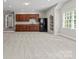 Basement featuring a kitchenette with wood cabinets and black appliances at 13029 Whisper Creek Dr, Charlotte, NC 28277