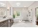 Elegant bathroom featuring a soaking tub, glass-enclosed shower, and modern fixtures at 13029 Whisper Creek Dr, Charlotte, NC 28277