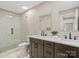 Modern bathroom with double vanity, marble floors, and sleek glass shower at 13029 Whisper Creek Dr, Charlotte, NC 28277