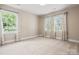 Bedroom with neutral carpet and lots of natural light from two windows at 13029 Whisper Creek Dr, Charlotte, NC 28277