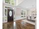 Grand foyer with soaring ceilings, hardwood floors, and elegant front door at 13029 Whisper Creek Dr, Charlotte, NC 28277
