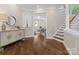 Open foyer view with hardwood flooring, staircase, and access to the living room at 13029 Whisper Creek Dr, Charlotte, NC 28277