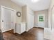 Hallway featuring hardwood floors, a front door, and an integrated bench at 13029 Whisper Creek Dr, Charlotte, NC 28277