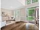 Bright living room with large windows, hardwood floors, and comfortable seating arrangement at 13029 Whisper Creek Dr, Charlotte, NC 28277