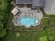 Aerial perspective of swimming pool with lounge seating, spa, and meticulously landscaped grounds at 13029 Whisper Creek Dr, Charlotte, NC 28277