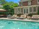 Relax by the poolside on comfortable lounge chairs in this outdoor oasis with a covered seating area at 13029 Whisper Creek Dr, Charlotte, NC 28277