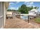 Wooden deck overlooking a backyard pool with a covered dining area and a shed at 131 Scotland Dr, Mooresville, NC 28115
