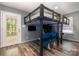 Bedroom showcasing a custom-built loft bed with stadium seating below and door to exterior at 131 Scotland Dr, Mooresville, NC 28115