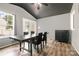 Dining area with a vaulted ceiling, modern lighting, and elegant wood-look floors at 131 Scotland Dr, Mooresville, NC 28115