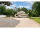 Home exterior showing a driveway, two-car garage, basketball hoop, and partial view of the pool at 131 Scotland Dr, Mooresville, NC 28115