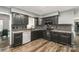 Modern kitchen with black cabinetry, stainless steel appliances, granite countertops, and tile backsplash at 131 Scotland Dr, Mooresville, NC 28115
