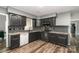 Modern kitchen with black cabinetry, stainless steel appliances, granite countertops, and tile backsplash at 131 Scotland Dr, Mooresville, NC 28115
