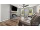 Living room with hardwood floors, stone fireplace with electric insert, and leather sofa at 131 Scotland Dr, Mooresville, NC 28115