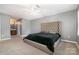 Large main bedroom with carpeting, tufted headboard, neutral paint, and ensuite bathroom at 131 Scotland Dr, Mooresville, NC 28115