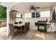 Covered patio with a dining table, grill, and ceiling fan, ideal for outdoor entertaining at 131 Scotland Dr, Mooresville, NC 28115