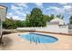 Swimming pool and patio area with lounge chairs, fenced for privacy, and lush landscaping at 131 Scotland Dr, Mooresville, NC 28115