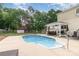 Backyard pool featuring a surrounding patio, fenced area, and a covered seating area at 131 Scotland Dr, Mooresville, NC 28115