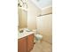 Cozy bathroom with wood vanity, tile floors, and a neutral shower curtain at 14837 Dungannon Ct, Charlotte, NC 28278