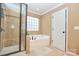 Serene bathroom featuring a glass shower and soaking tub with tile accents and recessed lighting at 14837 Dungannon Ct, Charlotte, NC 28278