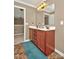 Bathroom with double sink vanity, white countertops, neutral walls, and brown tile flooring at 14837 Dungannon Ct, Charlotte, NC 28278