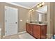 Bathroom with dual sinks, granite counters, and wooden cabinets at 14837 Dungannon Ct, Charlotte, NC 28278