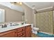 Bathroom features a double sink vanity with a large mirror, neutral walls, tile flooring, and toilet at 14837 Dungannon Ct, Charlotte, NC 28278