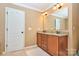 Bathroom featuring double vanity with granite countertops, tile floors, and custom lighting at 14837 Dungannon Ct, Charlotte, NC 28278