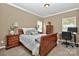 Inviting bedroom featuring a comfortable bed, neutral walls, and an adjacent desk area at 14837 Dungannon Ct, Charlotte, NC 28278
