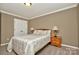 Bedroom with beige walls, carpet flooring, a double bed with lamps, and double-door closet at 14837 Dungannon Ct, Charlotte, NC 28278
