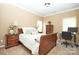 Comfortable bedroom featuring a sleigh bed, bedside tables, lamps, and a cozy workspace at 14837 Dungannon Ct, Charlotte, NC 28278