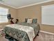 Cozy bedroom with a comfortable bed, and exercise bike by the window at 14837 Dungannon Ct, Charlotte, NC 28278
