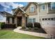 Beautifully landscaped front yard and stone accents adorn this charming home at 14837 Dungannon Ct, Charlotte, NC 28278