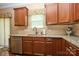 Well-lit kitchen with stainless steel appliances, granite countertops, tile backsplash, and rich wood cabinetry at 14837 Dungannon Ct, Charlotte, NC 28278