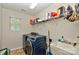 Laundry room featuring washer, dryer, sink, shelves, neutral walls, and tiled floor at 14837 Dungannon Ct, Charlotte, NC 28278