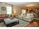 Comfortable living room with hardwood floors, a plush leather sofa, and neutral accents at 14837 Dungannon Ct, Charlotte, NC 28278