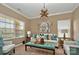 Cozy living room featuring a modern chandelier, stylish decor, and two sun-filled windows at 14837 Dungannon Ct, Charlotte, NC 28278