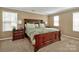 Comfortable bedroom with a large bed, bedside tables, and plenty of natural light from multiple windows at 14837 Dungannon Ct, Charlotte, NC 28278