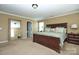 Spacious primary bedroom featuring a large bed, bedside tables, lamps and a large mirror at 14837 Dungannon Ct, Charlotte, NC 28278