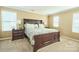 Bright primary bedroom featuring a large bed, bedside tables, lamps and natural light at 14837 Dungannon Ct, Charlotte, NC 28278