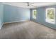 Light blue bedroom featuring carpeted flooring, ceiling fan, and natural light from dual windows at 1507 Chadmore Nw Ln, Concord, NC 28027