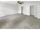 Bedroom featuring carpeted flooring, ceiling fan, large closet space, and natural light at 1507 Chadmore Nw Ln, Concord, NC 28027