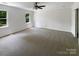 Large bedroom with fresh paint, carpeting, ceiling fan, and natural light at 1507 Chadmore Nw Ln, Concord, NC 28027