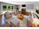 Bright living room with hardwood floors, fireplace, and French doors leading to outdoor deck at 1507 Chadmore Nw Ln, Concord, NC 28027