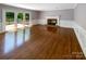 Spacious living room featuring hardwood floors, a fireplace and French doors leading to the deck at 1507 Chadmore Nw Ln, Concord, NC 28027