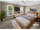 Cozy bedroom with large windows, ceiling fan, and stylish furnishings at 1507 Chadmore Nw Ln, Concord, NC 28027